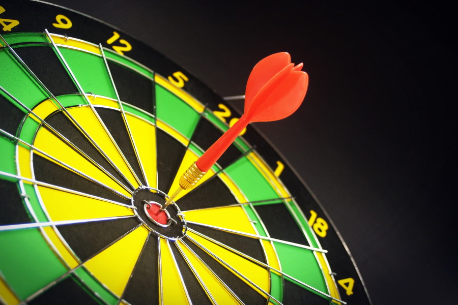 A dart scores a bullseye on a dartboard