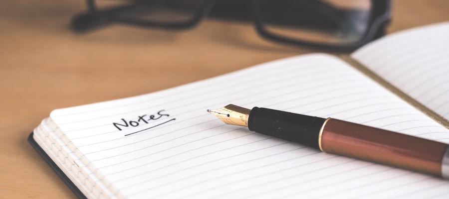 An open note book and fountain pen, ready to take notes