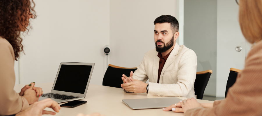 Professionals gathered at a tender support meeting for presentation coaching